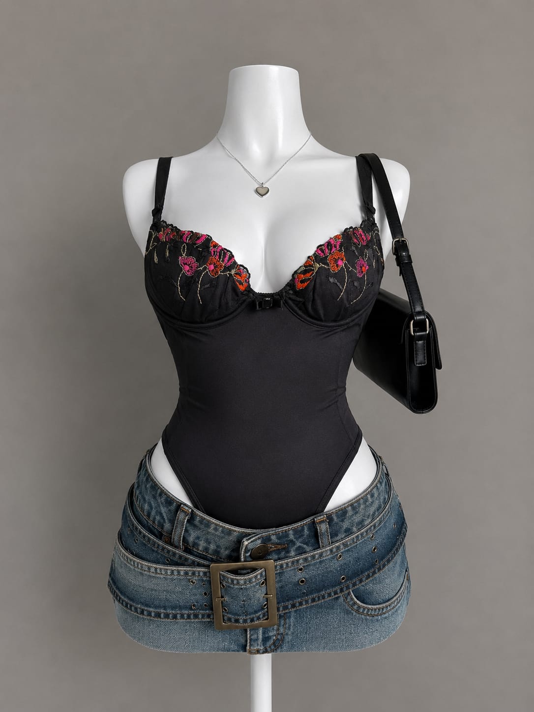 Black bodysuit with colorful floral embroidery along neckline on mannequin