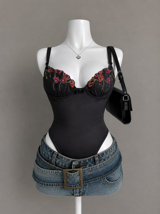 Black bodysuit with colorful floral embroidery along neckline on mannequin