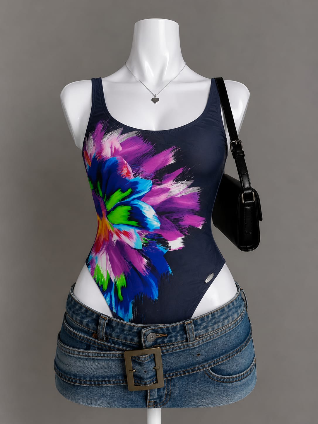 Navy blue bodysuit with multicolor abstract floral burst print on mannequin