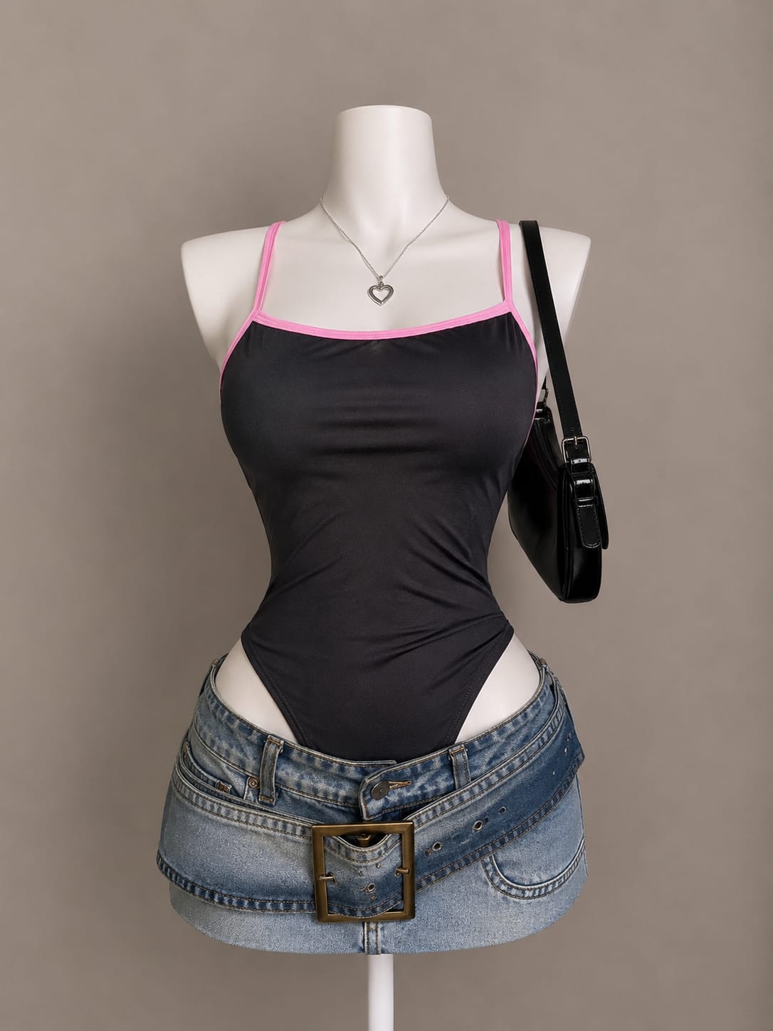 Black bodysuit with pink contrast trim along neckline and spaghetti straps on mannequin