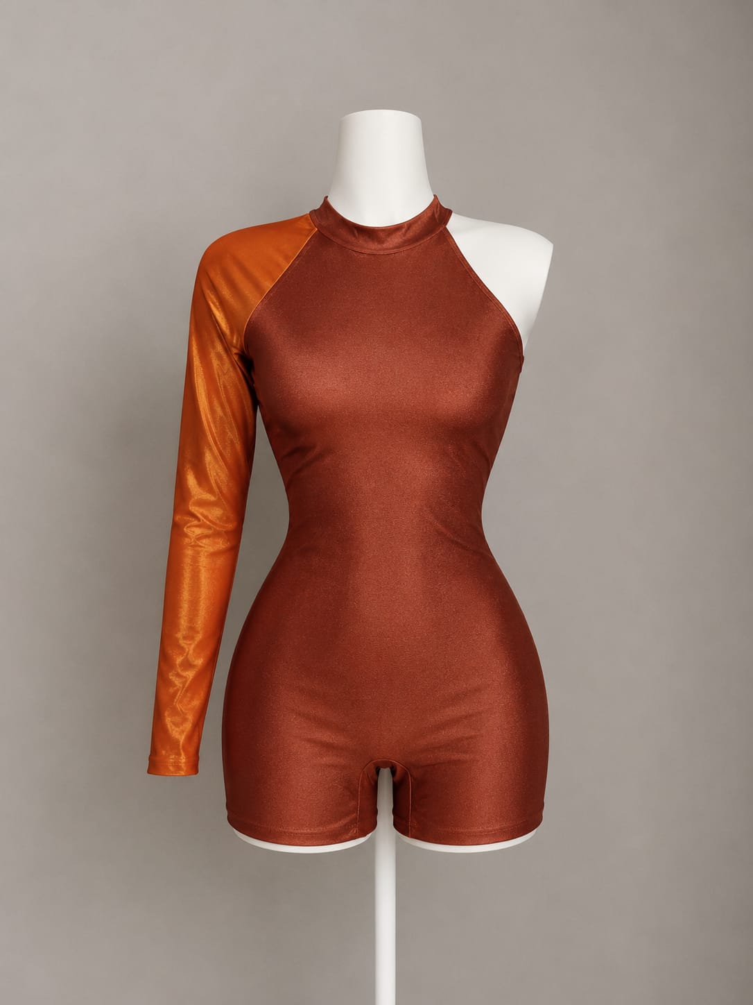 Rust burnt orange one-shoulder long sleeve bodysuit with mock neck and fitted shorts bottom on mannequin