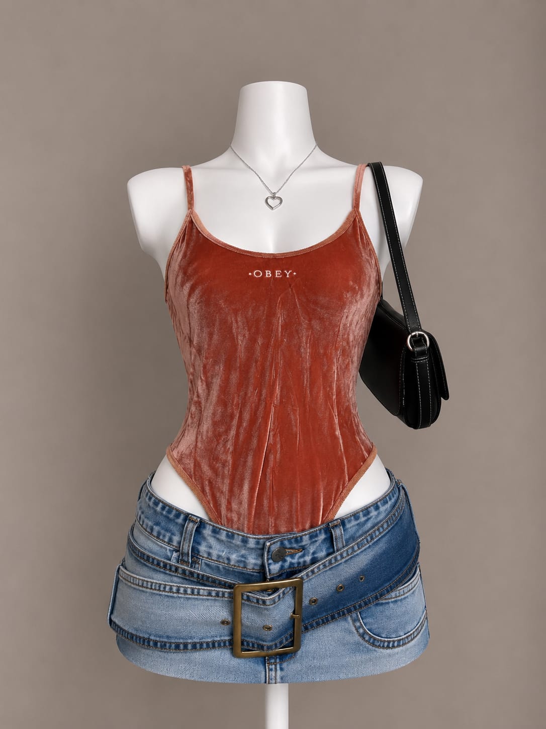 Rust crushed velvet OBEY logo spaghetti strap bodysuit on mannequin