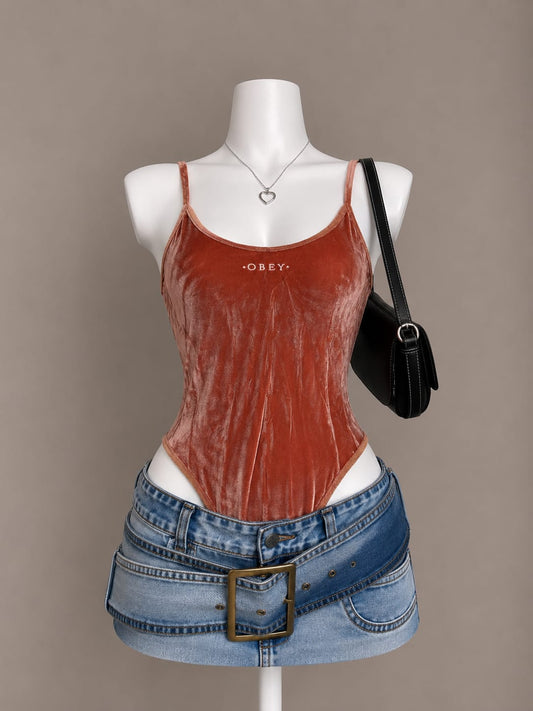 Rust crushed velvet OBEY logo spaghetti strap bodysuit on mannequin